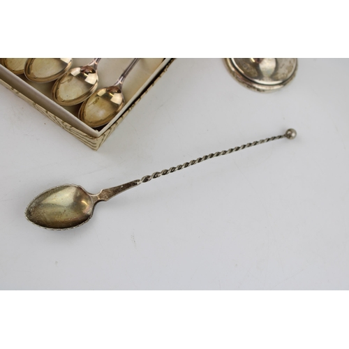 567 - A set of boxed silver spoons (60g) together with a silver spoon marked .830 (weight 12g) together wi... 