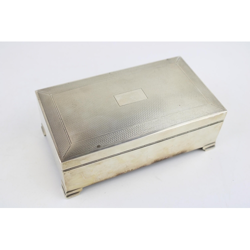 576 - Large silver cigarette box, engineered decoration, vacant cartouche, wooden interior, Birmingham 195... 