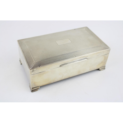 576 - Large silver cigarette box, engineered decoration, vacant cartouche, wooden interior, Birmingham 195... 