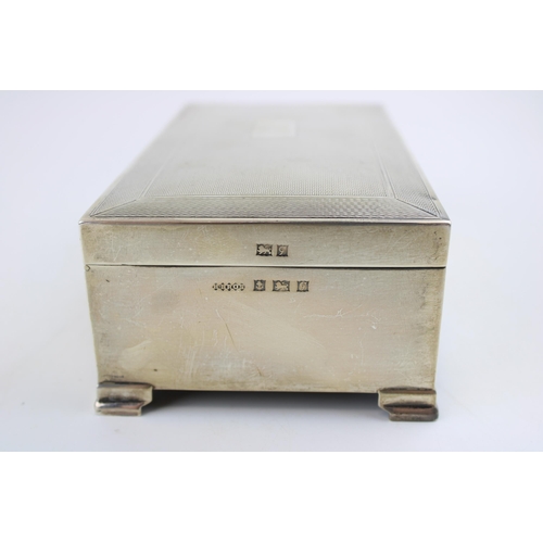 576 - Large silver cigarette box, engineered decoration, vacant cartouche, wooden interior, Birmingham 195... 