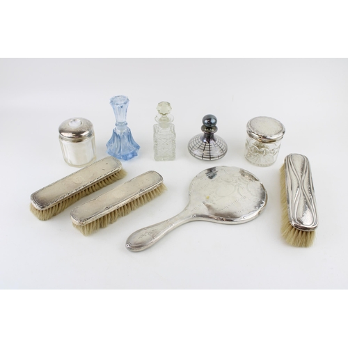 580 - A group of silver dressing table items, comprising three silver backed clothes brushes, and two silv... 