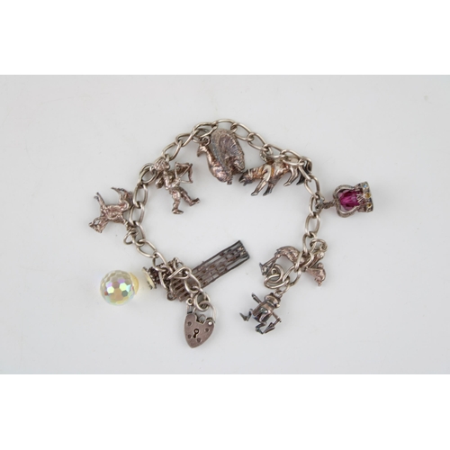 584 - A vintage silver charm bracelet. 34.3g.