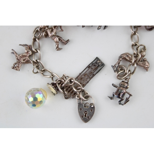 584 - A vintage silver charm bracelet. 34.3g.