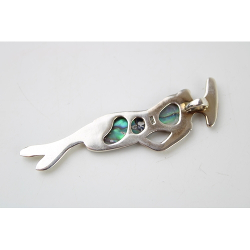 589 - Contemporary sterling silver pendant in the form of a lady, set abalone, 6.5cm tall.