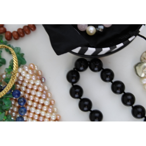 619 - Costume jewellery to include necklaces, a jaguar style bracelet, bangles and others (Qty).