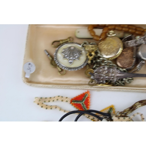 621 - Costume jewellery to include gilt metal lockets, metal albert chains, a watch key and others (Qty).