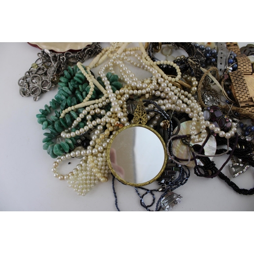 624 - Costume jewellery to include necklaces, a silver plated bird locket with necklace, a hand mirror, fa... 