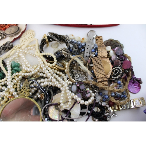 624 - Costume jewellery to include necklaces, a silver plated bird locket with necklace, a hand mirror, fa... 