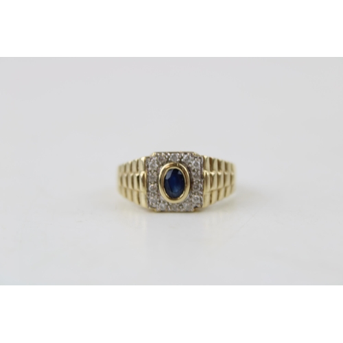 635 - A vintage gents 9ct gold ring set diamonds and sapphire. Ring size Z. Weight 6.3g.