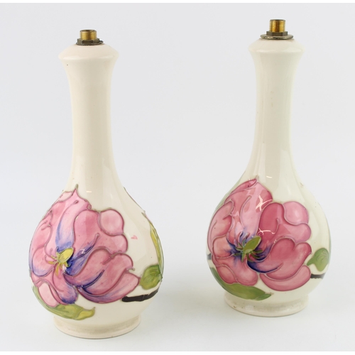 76 - A pair of Moorcroft lamp bases in the 'Magnolia' pattern. Height 23cm.