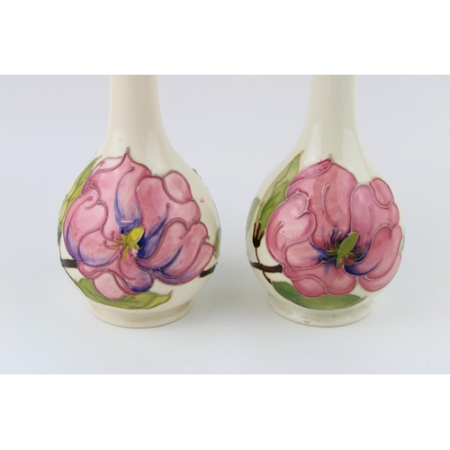 76 - A pair of Moorcroft lamp bases in the 'Magnolia' pattern. Height 23cm.