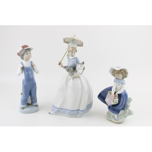 91 - A collection of figures to include LLadro / Nao 'Girl Holding Dog' a/f, 'Boy from Madrid' together w... 