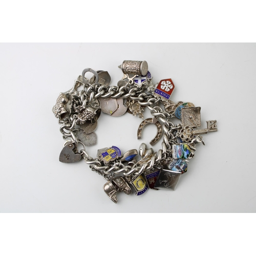 598 - Silver charm bracelet, circa 108g, to include animals, a key, a tankard and others (Qty).