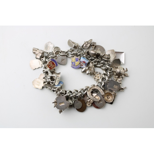 598 - Silver charm bracelet, circa 108g, to include animals, a key, a tankard and others (Qty).