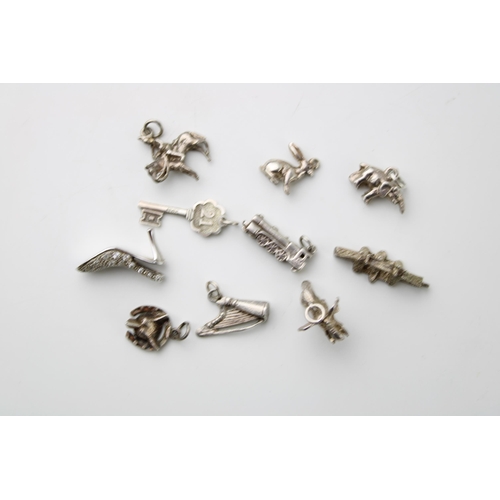 599 - A collection of 10 assorted silver charms to include a harp, a train and others (10).