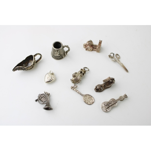 601 - A collection of 10 silver charms to include a tankard, a jug and others (10).