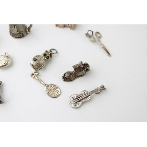 601 - A collection of 10 silver charms to include a tankard, a jug and others (10).