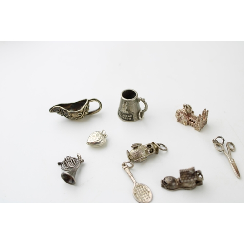 601 - A collection of 10 silver charms to include a tankard, a jug and others (10).