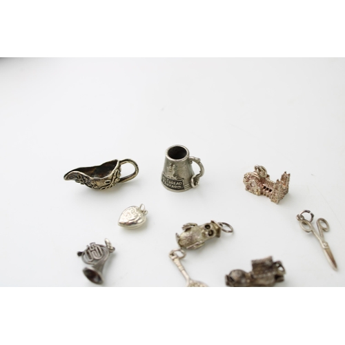 601 - A collection of 10 silver charms to include a tankard, a jug and others (10).