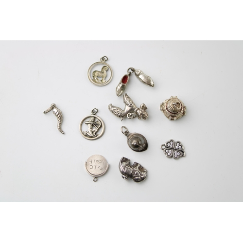 602 - A collection of 10 silver charms to include a bird, clogs and others (10).