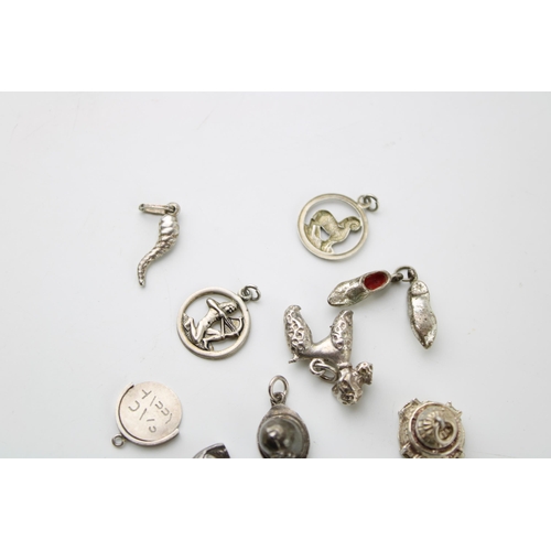 602 - A collection of 10 silver charms to include a bird, clogs and others (10).