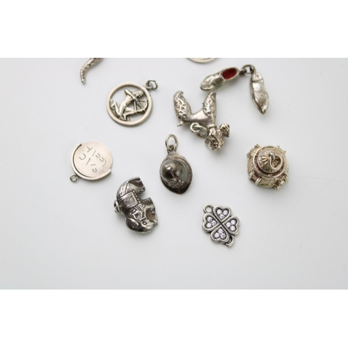 602 - A collection of 10 silver charms to include a bird, clogs and others (10).