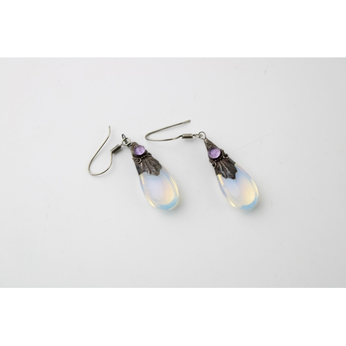 603 - A pair of silver and moonstone earrings (2).