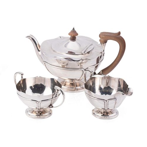 296 - An Edwardian Art Nouveau silver tea set, of organic curvilinear form with raised trailwork decoratio... 