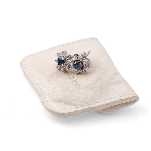 365 - A pair of 9ct white gold, diamond and sapphire earrings of flowerhead form, 2.0g.