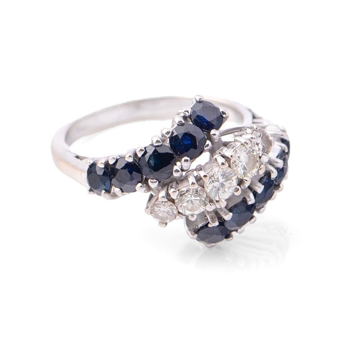 371 - 18ct white gold lady's crossover ring, set diamonds and sapphires, size H, 4.4g.