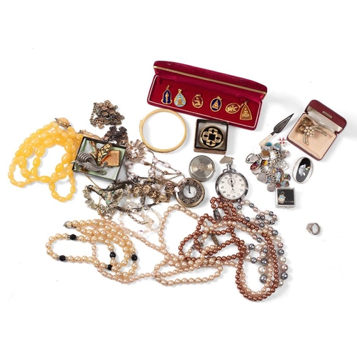 409 - A silver charm bracelet with a large number of shield charms from various locations, mostly UK and E... 