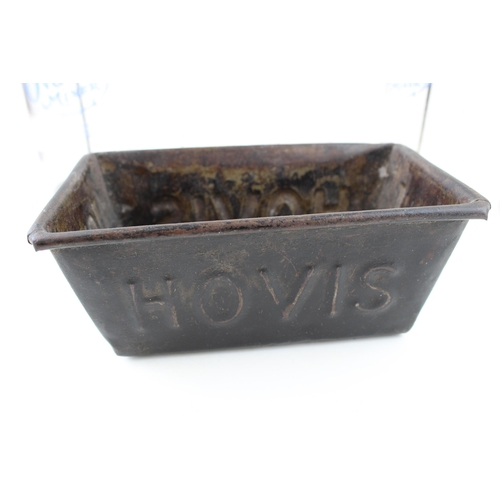 105 - A collection of advertising items to include 'Hovis' bread tin, together with glass Ovaltine and Hor... 