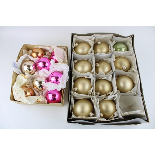 144 - Two boxes of vintage christmas decorations to include glass baubles in pink and silver and later set... 