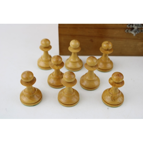 153 - A 20th century wooden chess set, in wooden base, complete, unmarked, box sticker  Schach Zentrale H.... 