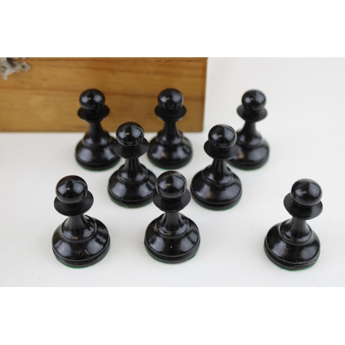 153 - A 20th century wooden chess set, in wooden base, complete, unmarked, box sticker  Schach Zentrale H.... 