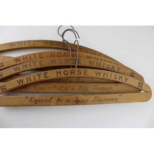 21 - Four vintage coat hangers adverting 'White Horse' Scotch Whiskey. Width 43cm.