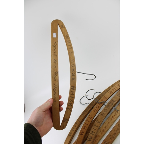 21 - Four vintage coat hangers adverting 'White Horse' Scotch Whiskey. Width 43cm.