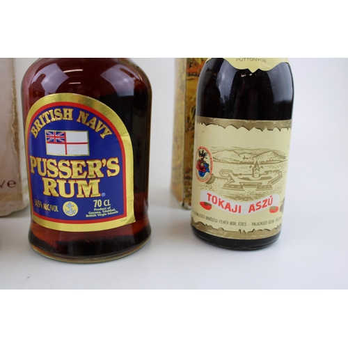 211 - A 70cl Pusser's Rum 54.5% proof, a 70cl Bell's Scotch Whiskey 40% vol together with a Tokaji Aszu. (... 