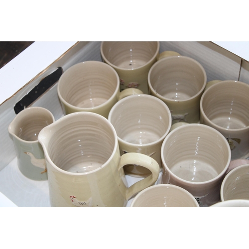 228 - A large collection of Jane Hogben Pottery in floral and animal patterns to include 14 mugs,2 pots, 3... 