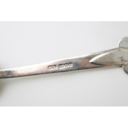 269 - Silver Arts & Crafts table spoon, London 1994, J O Craven, 12.5cm long, tribal face to bowl, 24.3g.