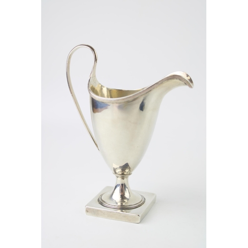 274 - A George III Peter and Anne Bateman silver cream jug, of helmet form, with reeded edge on square ped... 