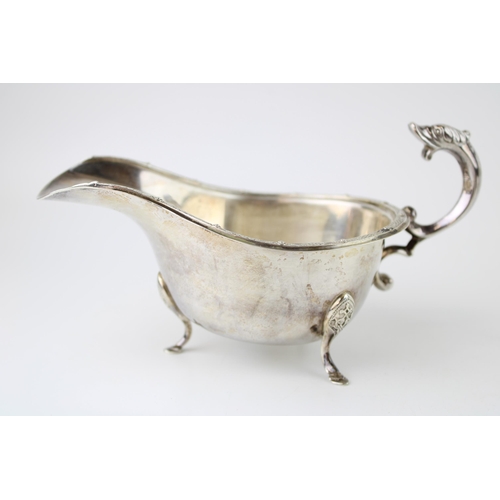 275 - A silver sauce boat, with dragon handle and Celtic knot work rim and three hoofed feet, Deakin and F... 