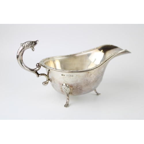 275 - A silver sauce boat, with dragon handle and Celtic knot work rim and three hoofed feet, Deakin and F... 