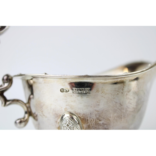 275 - A silver sauce boat, with dragon handle and Celtic knot work rim and three hoofed feet, Deakin and F... 