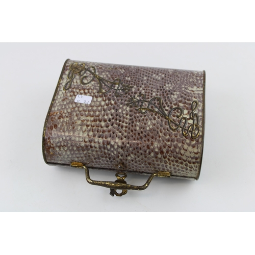 3 - An early 20th century Huntley & Palmer, Art Nouveau faux shagreen tin biscuit tin in the form of a h... 