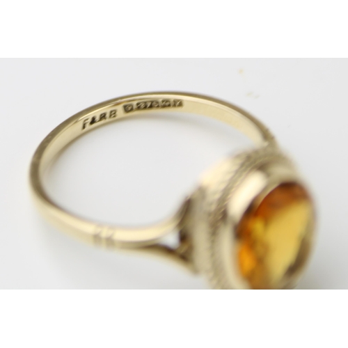 329 - A 9ct gold and citrine dress ring, size M/N, 2.5g.