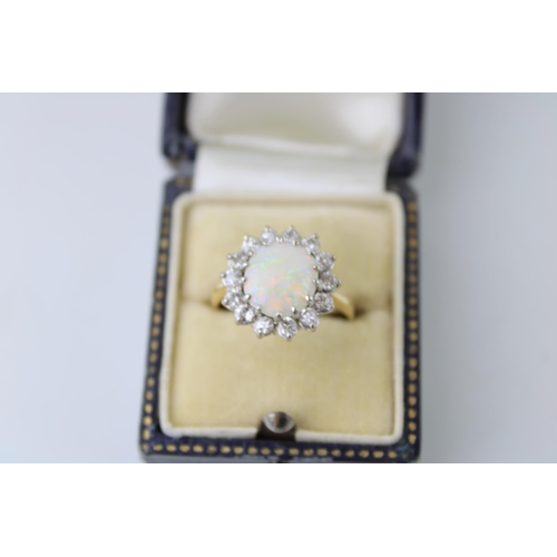 342 - An 18ct gold, opal and diamond dress ring, the single circular opal cabochon of approximately 10mm d... 