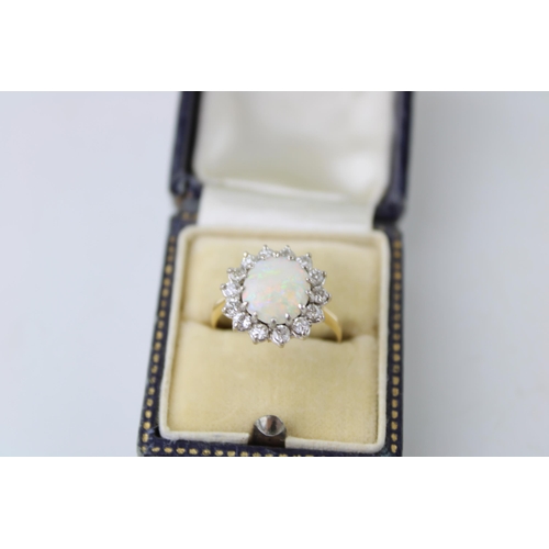 342 - An 18ct gold, opal and diamond dress ring, the single circular opal cabochon of approximately 10mm d... 