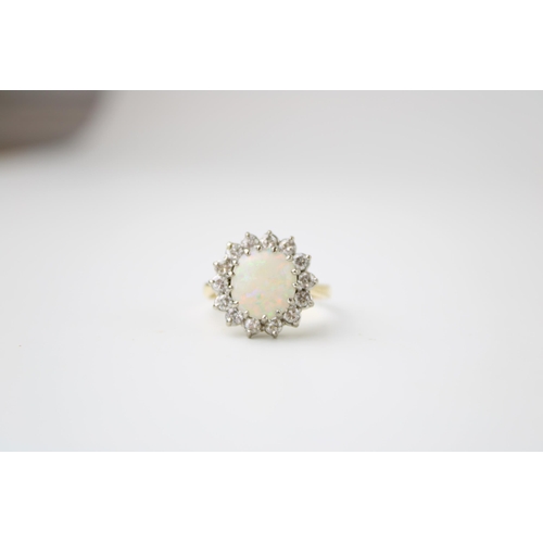 342 - An 18ct gold, opal and diamond dress ring, the single circular opal cabochon of approximately 10mm d... 