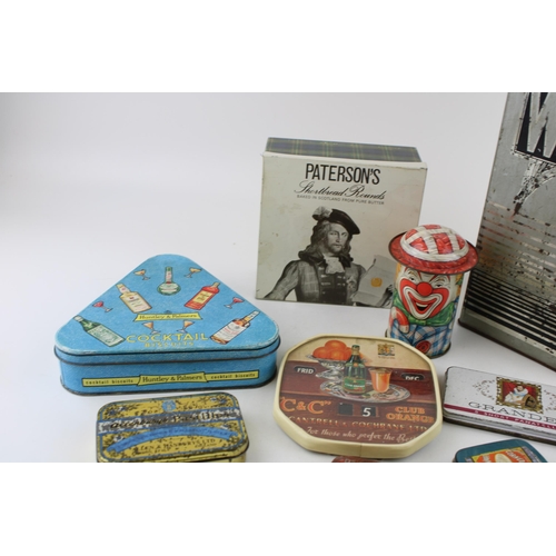 40B - A collection of advertising tins to include examples by 'Huntley & Palmers', 'Cap-Tins' clown tin, a... 